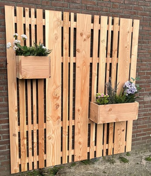 Verberg een saaie muur met dit houten tuinscherm buiten voor kruiden en planten